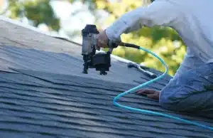 Roofing expert working on roof replacement in a San Diego home